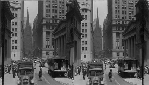 Looking west on Wall Street to 285-foot spire of Trinity Church, new dwarfed by skyscrapers of modern New York