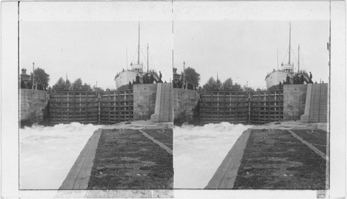 "Down-lockage" in canal, (letting water through gates to equalize level), Sault Ste. Marie. Michigan