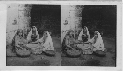 Women of Ramallah Grinding Corn at their Primitive Mill, Palestine