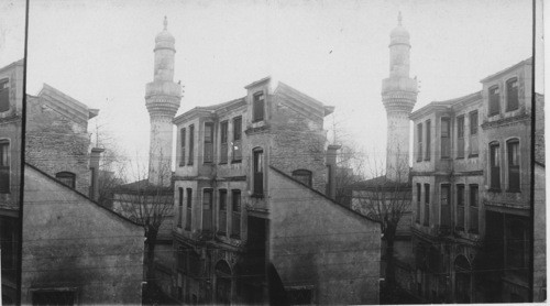 A Moslem muezzin crying the call to prayer from a minerat in Constantinople. Turkey