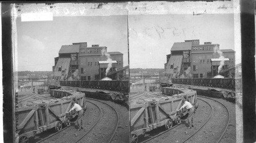 Loaded cars ready at foot of plane and cars being hoisted into breaker - Anthracite Mine. Penna