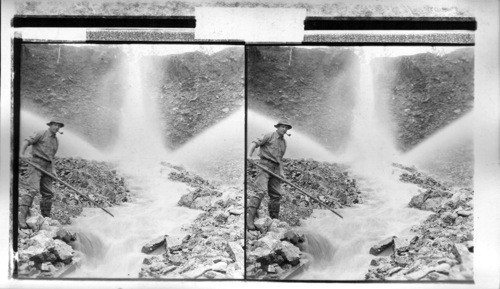 Washing down earth, gravel and rock into flume to be separated from the gold. Oregon