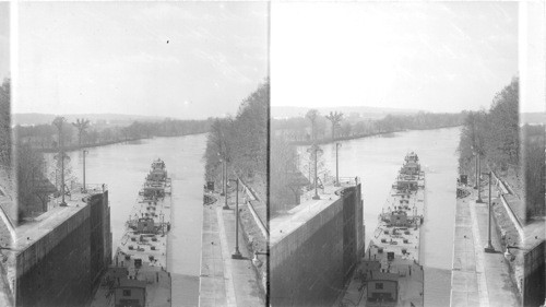 Boat and oil barges entering the lock. ? Tennessee, Georgia, Alabama