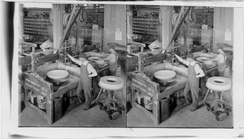 Making Carborundum wheels into proper size and shape before placing in kilns. Niagara Falls. New York