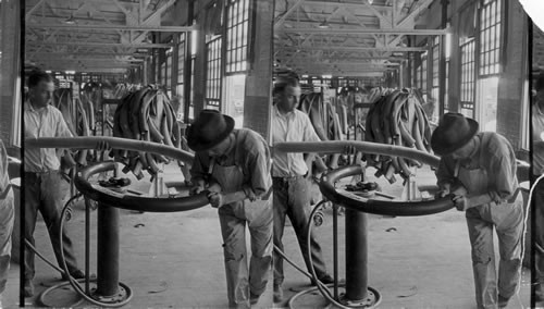 Stripping on tube on mandrel before sending to cure, Rubber Factory, Akron, Ohio