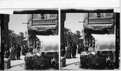 ENTRANCE TO FIRST COURTYARD OF GOLDEN MOSQUE AT MESHED, EASTERN IRAN. GOLDEN DOME VISIBLE TO LEFT OF LARGE GATE