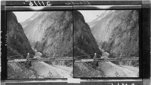 Bear Creek Suspension Bridge on the Richard Highway near Valdez, built by the war department and the highway maintained at a cost of nearly a million dollars a year, Alaska