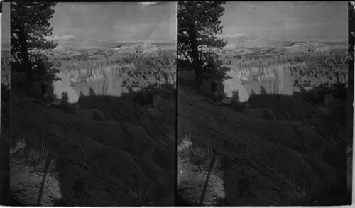 From top of rim of Bryce Canyon near Bryce Lodge west looking down into Bryce Canyon. Utah. (If even the stereographs could convey a true idea of topography you could see that it was impossible to place the man closer to camera & as for his being farther down was out of the question - This ground here is very crumbly & extremely dangerous - It was fortunate at that time that this man was there - He is a Norwegian painter & a real mountain climber otherwise you would have had no life at all in this & in 47979 & 47955. Look over composition of views on this rim taken by Peabody & then you will agree that good exposure is all right but composition is just as important - & in general his composition in all his work is no good fro stereo point of view.)