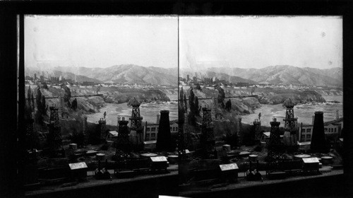 California Exhibit, A Century of Progress, Chicago, 1933. [Painting of California coast (background), Models of oil wells (foreground)