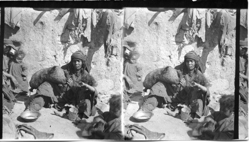 A Bedouin Woman of Palestine Churning with a Goatskin