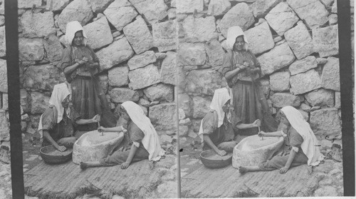 Women grinding at the mill. Palestine