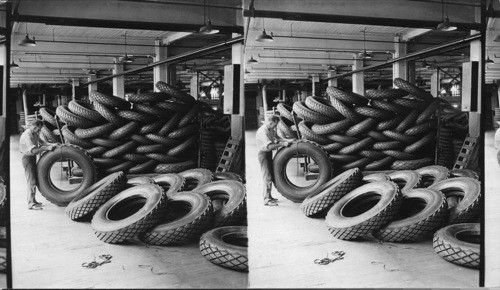 Final Inspection Room, man trimming off surplus overflow on tire after coming from curing (size 42x9) Akron, Ohio