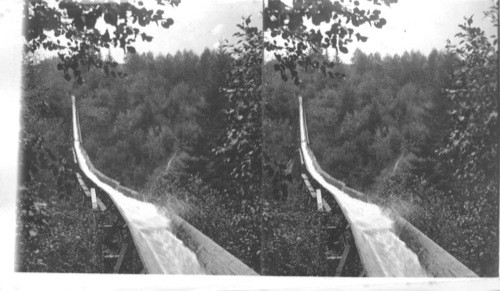 Fluming lumber four miles from mill to railway in the Cascade Mountains, Oregon