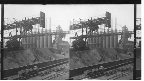 Picking up buckets of coat with huge cranes. Blast furnaces. Ore storage and overhead carrier. Steel Works. Homestead, Penna