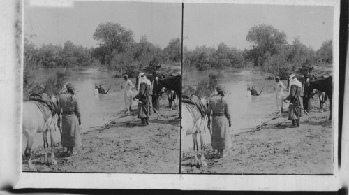 Baptizing in the Jordan. Palestine