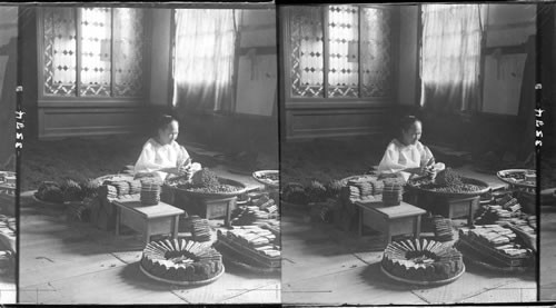 Trimming the ends of finished cigars and packing them into bunches Manila. Philippine Islands