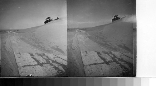 30 Box 8 Catapillar [Caterpillar] Tractor clearing road of Drifted Sand near Thermal, Calif