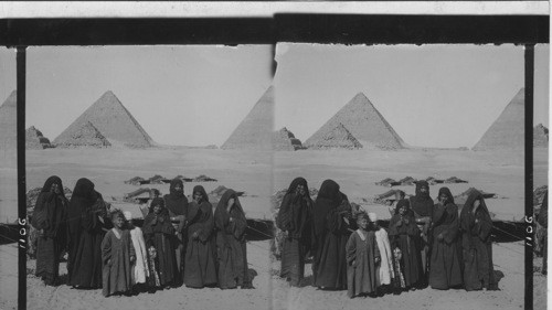 Bedouins, their homes and the distant Pyramids, Egypt