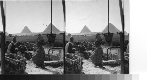 The old and new in Egypt - water carrier and a pumping engine at well near Gizeh Pyramids