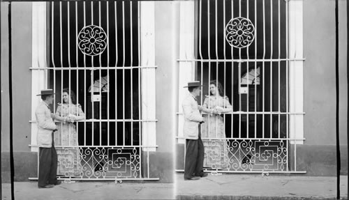 Cuban Lovers - courting through the barred windows. Cuba