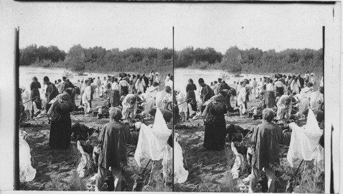 Russian Pilgrims along the shore of the sacred Jordan. Palestine