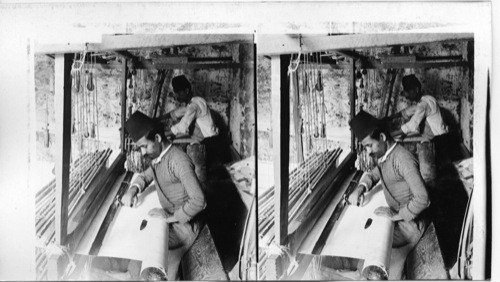 Weaving the finest of Syrian silk, on a primitive loom, Mt. Lebanon district. Syria