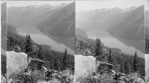 Probably Glacier National Park Lake Louise? [View of lake or river running through forested mountains, seen from above.]