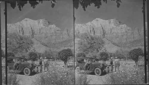 In Springdale looking No. to West Temple to right high up is Altar of Sacrifice with red blood streaks coming down from which it gets its name. Zion National Park. Utah