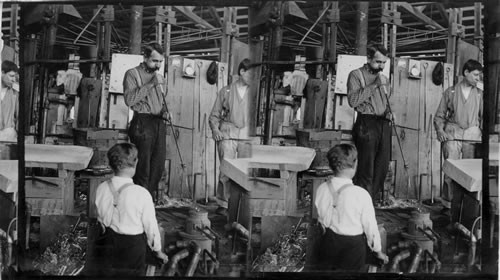 Blowing the bottle into required shape in a mold. American Glass Bottle Industry, Penna