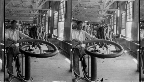 Stripping off cured tube from circular mandrel, Rubber Factory, Akron, Ohio