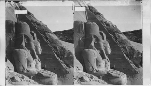 The sixty-five-foot portrait statue of Rames II before rock-hewn temple of Abu Simbel, Egypt