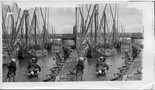 Water Carriers at the Nile, bearing primitive water bottles, Great Nile Bridge in background