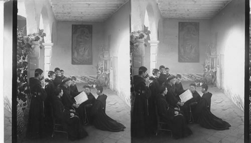 Interior San Francisco Convent. Boy students interested in instructor's story - just as found at their work. Lima, Peru