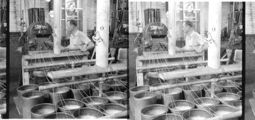 Granulating Smokeless Powder at the DuPont smokeless powder plant, Carney's Point Penn's Grove, N.J. across the river from Wilmington, Del. A close-up of the rifle powder cutting machine with strings of powder being fed into it. 1928 - GOOD. E.J. DuPont de Nemours & Co., Inc