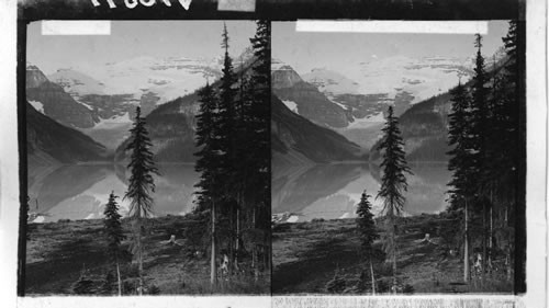 The placid waters of Lake Louise and Mt. Victoria, Rocky Mts., Alberta. Canada