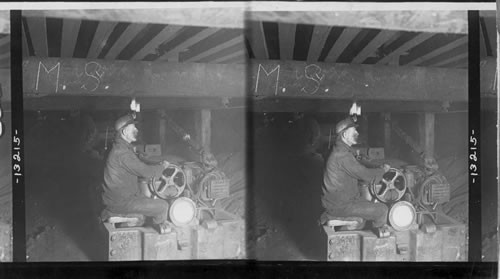 A motor with a train of loaded coal cars in a coal mine