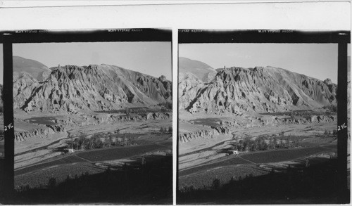 246 Scenery near Bamian, Afgh. On the ridge two old fortification towers can be seen and caves that used to be monk cells. Small clover fields near the stream