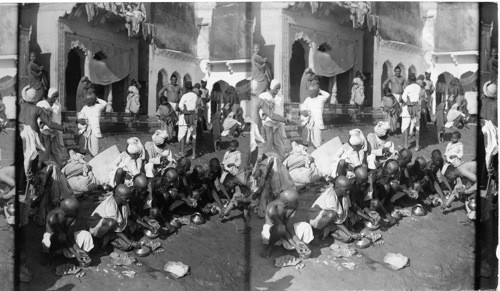 Hindus sacrificing food to the sacred river of Jumma, India