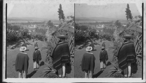 Characteristic costumes of native travelers on hill overlooking Ambato. Ecuador