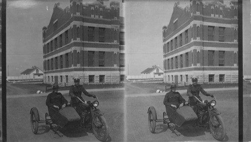 Mounted Police going out in a rush with a side car. Canada. Regina