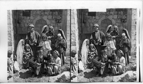 A Greek Priest blessing the Village Children in Ramah. Asia. Palestine