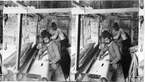 Weaving the finest of Syrian silk on a primitive loom. Mt. Lebanon district. Syria