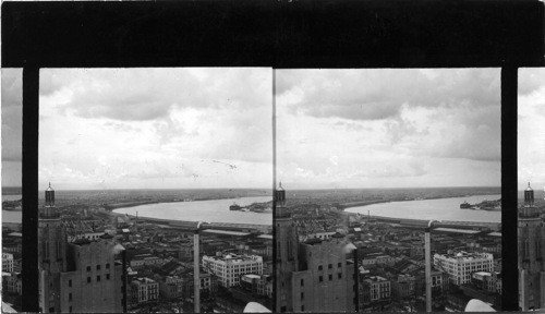 From tower Hibernia Bank Building, showing bend in river on which city was founded. Skyscraper at left is American Bank Building, New Orleans, La