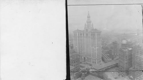 For slide only. Looking down from Woolworth tower towards Park Row, Municipal Bldg. New York City