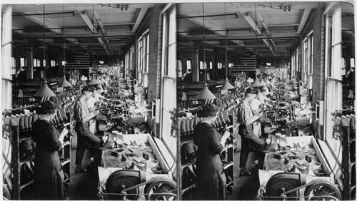 Cleaning and pressing the finished shoes in a factory at Rochester, N.Y