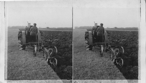 Two bottom tractor on fertile Nebraska field. Nebr