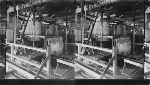 Where Jamaica Rum is made, - mixing cistern pump and vat in the liquor department of the Mona Sugar Estate, Jamaica