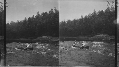 Shooting Rapids with canoe at Moon Dam Rapids on Moon River, Muskoka Lakes, Ont