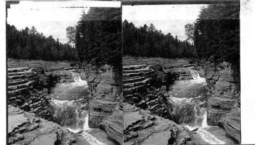 Famous natural steps and hurrying stream above the Falls of Montmorency near Quebec. Canada