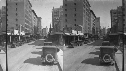 Looking a little north of east on Houston St. from near corner of St. Mary St. San Antonio. Texas